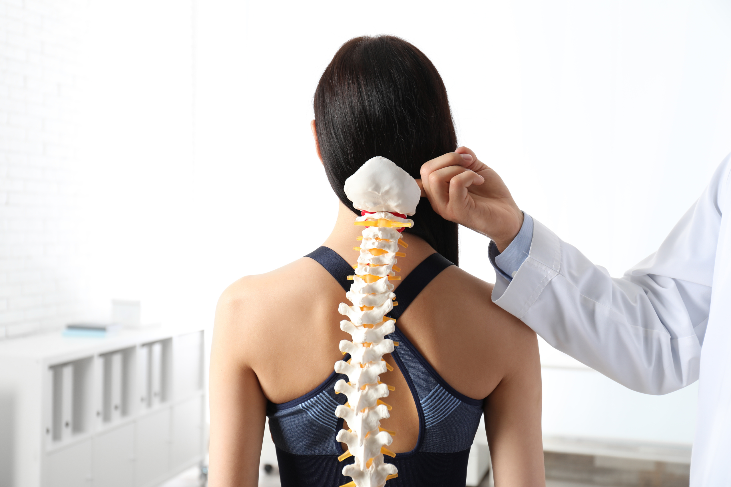 Chiropractor demonstrating spinal alignment treatment in Mesa