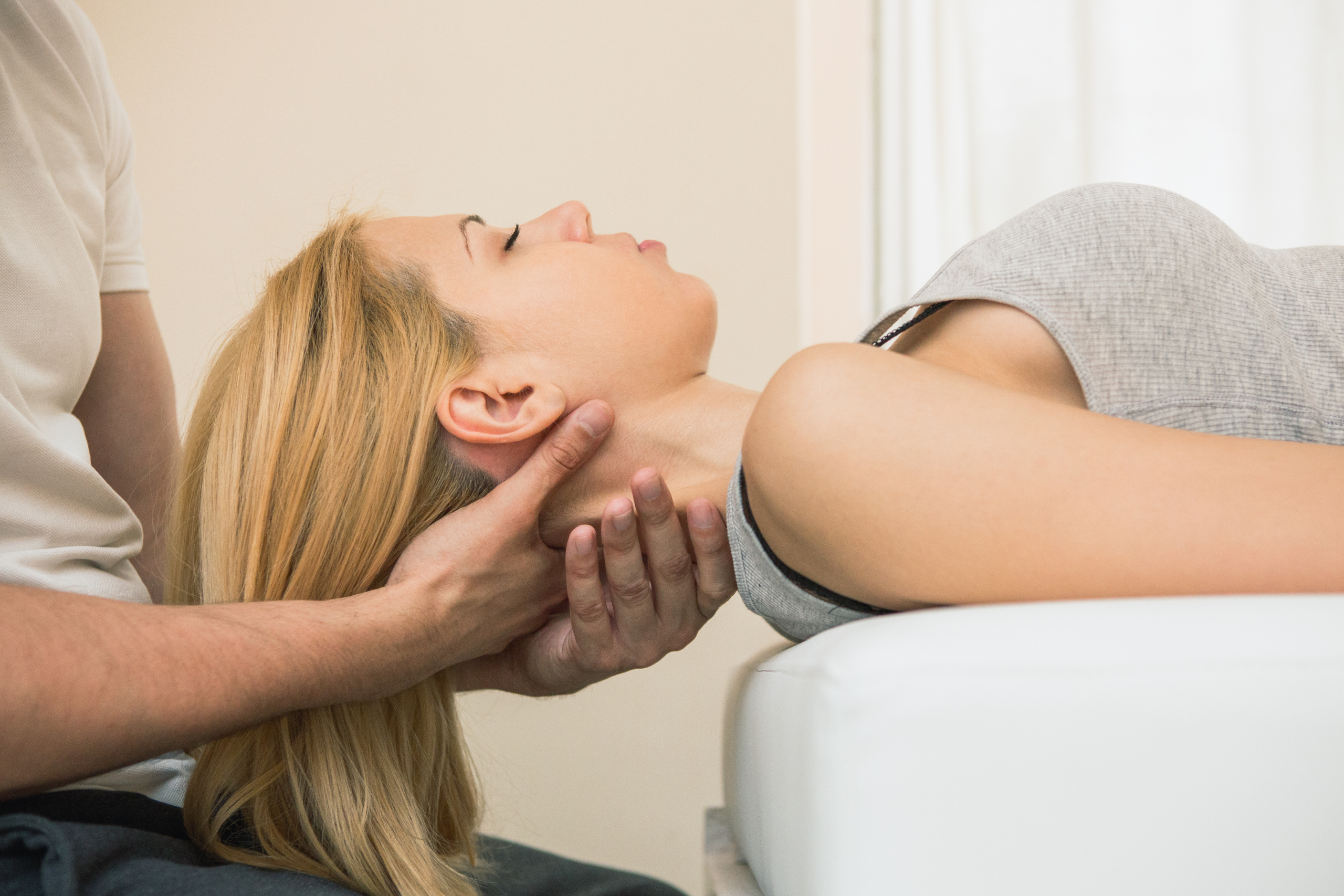 Chiropractor performing gentle neck adjustment for pain relief in Mesa AZ